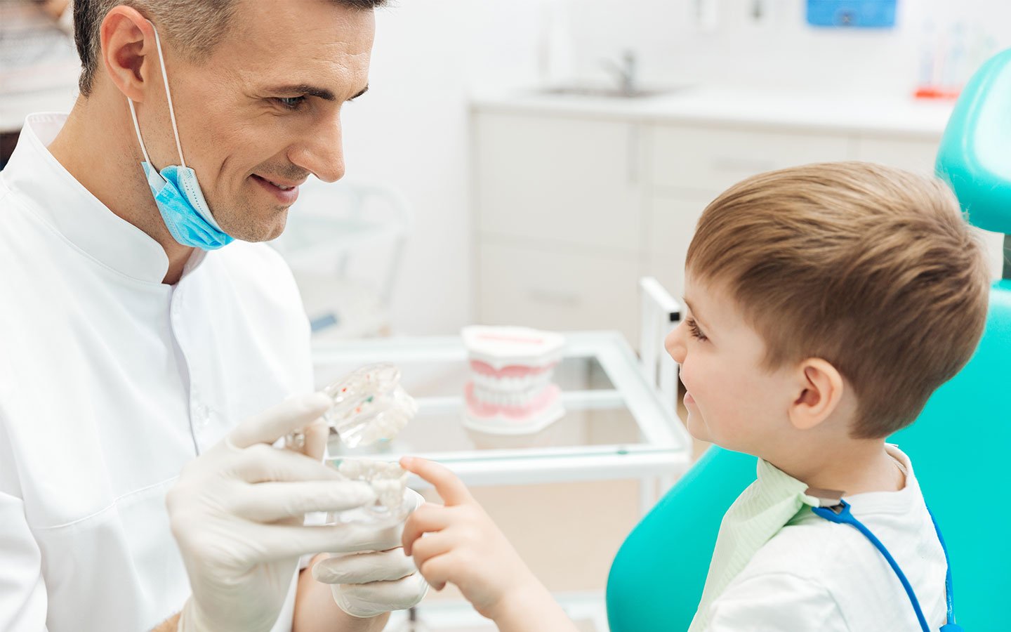 Pediatric dentist with a child patient at Nexus Dental Center