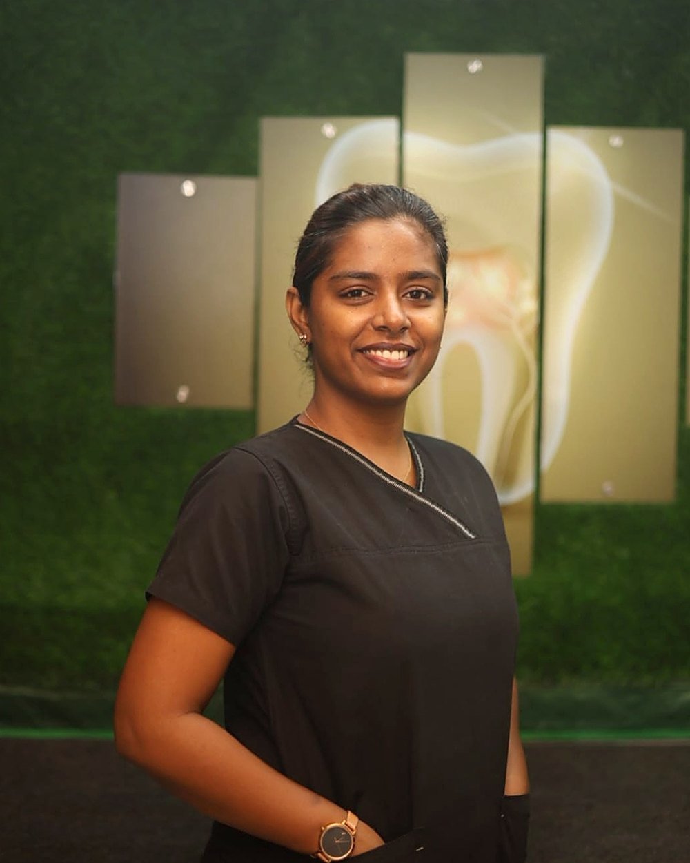 Dr. Akshayaa JC in clinic scrubs at Nexus Dental Center, Pudur, Ambattur